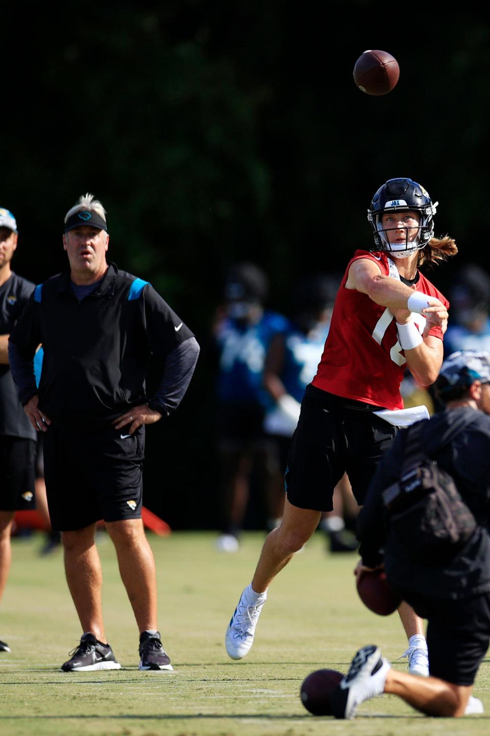 New head coach Doug Pederson looks on as Trevor Lawrence delivers a pass during preseason drills in Jacksonville.