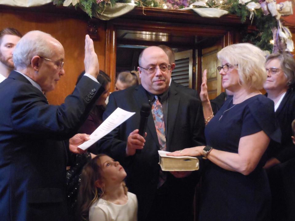 Massillon Mayor Kathy Catazaro-Perry (right) is sworn into office in December 2019 by Municipal Judge Edward Elum (left) after winning a third term in November of that year. Also pictured is the mayor's husband, Tony Perry (center), and her granddaughter, Brooklyn Wohlheter.