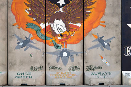 A mural at Bagram Airfield pictured on August 22, 2017, commemorates a previous deployment of the 555th Expeditionary Fighter Squadron to Afghanistan in 2015. Picture taken August 22, 2017. REUTERS/Josh Smith