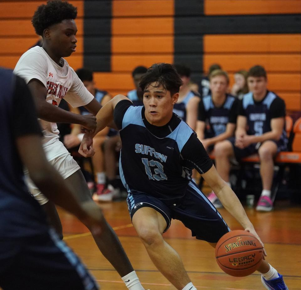 Suffern's Jake Pampolina (13) drives the baseline during boys basketball action against Spring Valley at Spring Valley High School on Friday, Jan. 26, 2024.