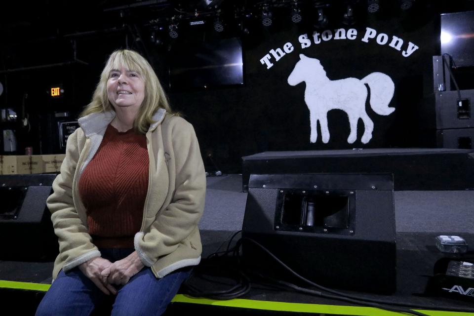 Asbury Park Press reporter Jean Mikle sits on the stage at the Stone Pony in Asbury Park.