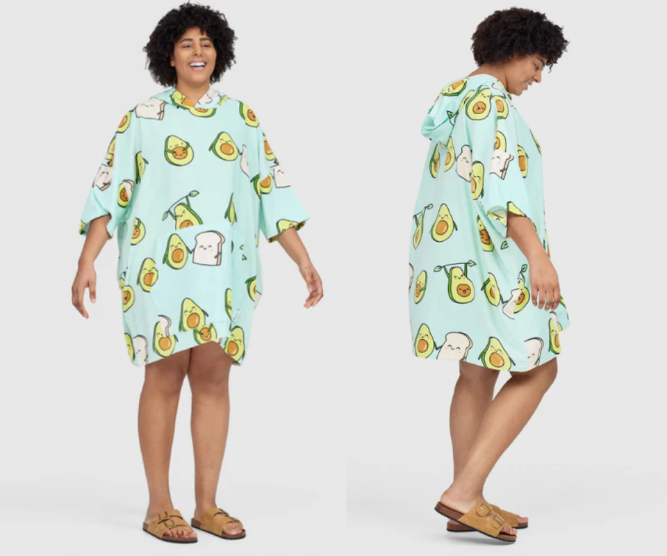 A woman wears the green Oodie beach avocado print against a pale background.