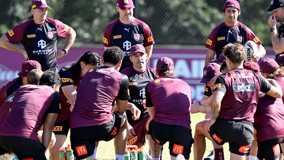 Pictured centre, Queensland coach Billy Slater addresses his players at Maroons training camp.