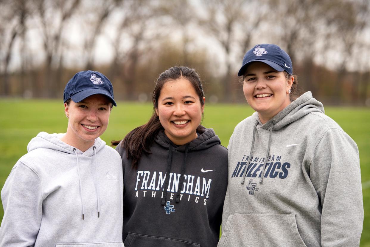 (L-R) Framingham head junior varsity softball coach Victoria George, varsity head coach Kaitlyn Seeto and varsity assistant coach Jill Jones, who all played together and graduated from FHS in 2017, take time out during softball practice at Framingham High School, April 30, 2024.