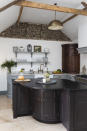 <p> In a characterful country property, the straight lines and hard edges of a typical kitchen can look a little&#x2026; square.&#xA0; </p> <p> In this Norfolk cottage, custom-made cabinets with curved profiles soften the space. The unusual design of the island creates a gathering space in the centre of the kitchen, and replicates the shape of the corner cabinet beyond. </p> <p> For added interest, a part of the cottage&#x2019;s original flint wall has been left exposed. </p>