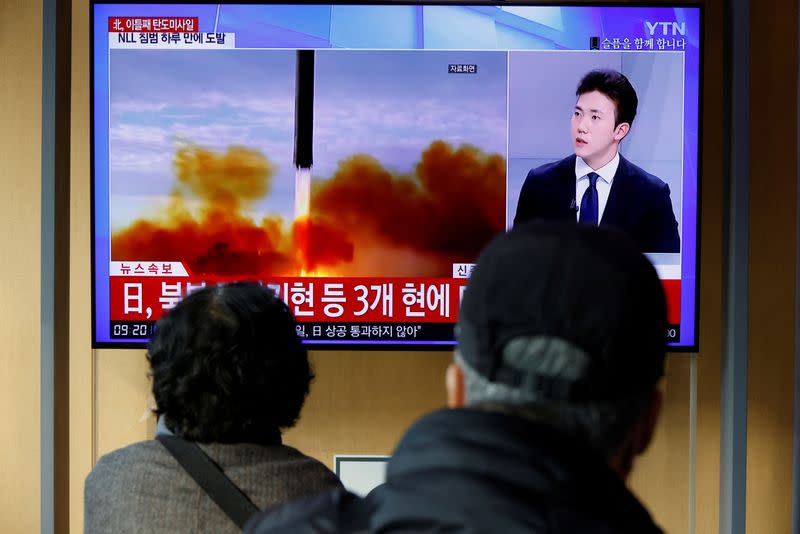 People watch a TV broadcasting a news report on North Korea firing a ballistic missile off its east coast, in Seoul