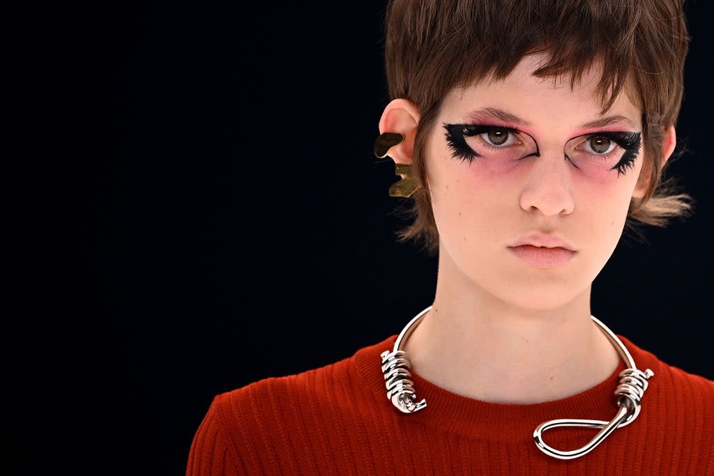 The controversial necklace on the catwalk (AFP via Getty Images)