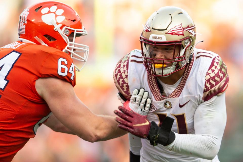 Clemson offensive lineman Walker Parks (64) blocks Florida State defensive end Jermaine Johnson II (11) during the second half of an NCAA college football game, Saturday, Oct. 30, 2021, in Clemson, S.C. (AP Photo/Hakim Wright Sr.)