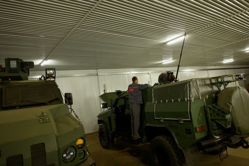 Employees check the exterior of a Novator armoured personnel carrier at a production facility of the 'Ukrainian Armor' company in Ukraine