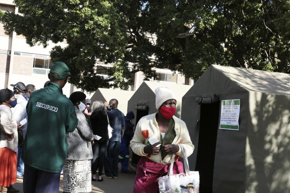 A woman holds her vaccination card after getting a second shot at a government hospital in Harare, Zimbabwe on Monday, Sept, 13, 2021. Many employers in Zimbabwe are mandating COVID-19 vaccines for their staff, and the government has its own requirement that its 500,000 employees get the shots. That sets the southern African nation apart from nearly every other on the continent, where the most immediate challenge is still simply acquiring enough doses. (AP Photo/Tsvangirayi Mukwazhi)