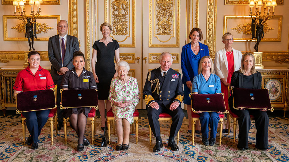 The queen and Prince Charles (center) at a July 2022 ceremony to recognize members of Britain’s National Health Service. - Credit: Aaron Chown/Getty