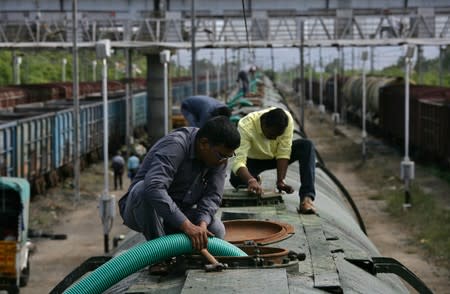 A worker fills a tanker train with water, which will be transported and supplied to drought-hit city of Chennai, at Jolarpettai railway station in the southern state of Tamil Nadu