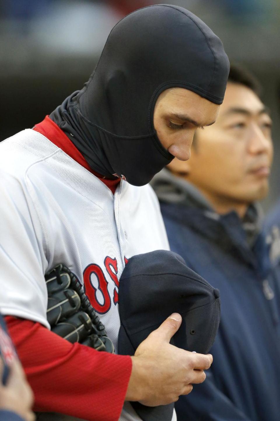 Boston Red Sox center fielder Grady Sizemore, left, stands with his teammates during a moment of silence for the victims of the Boston Marathon bombings, before the Red Sox's baseball game against the Chicago White Sox on Tuesday, April 15, 2014, in Chicago. (AP Photo/Charles Rex Arbogast)