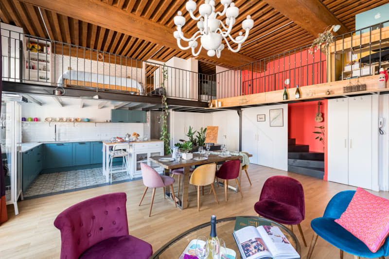 A lower living room area below the bedroom and office on the second floor.