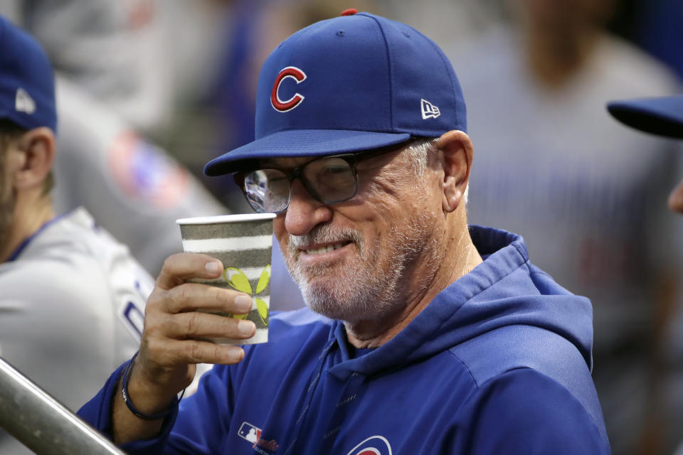 Chicago Cubs manager Joe Maddon salutes a fan from the dugout before a baseball game against the Pittsburgh Pirates in Pittsburgh, Wednesday, Sept. 25, 2019. (AP Photo/Gene J. Puskar)