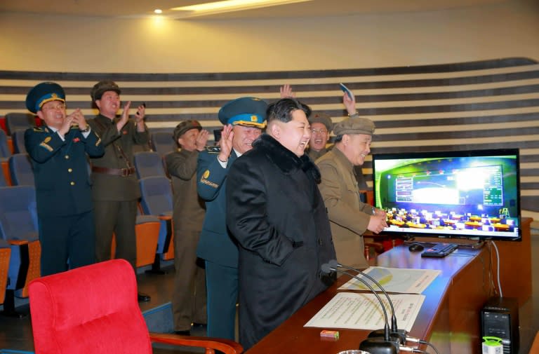 North Korean leader Kim Jong-Un (C) attends the rocket launch of the earth observation satellite Kwangmyong 4 at an undisclosed location in North Korea