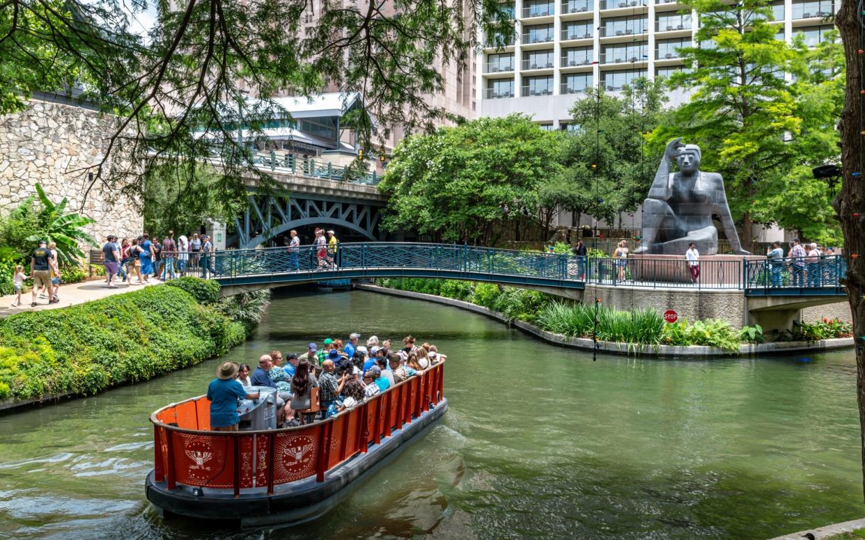 A boat ride along San Antonio's Riverwalk, by  Stargazer, a sculpture by Mexican artist Pedro Reyes