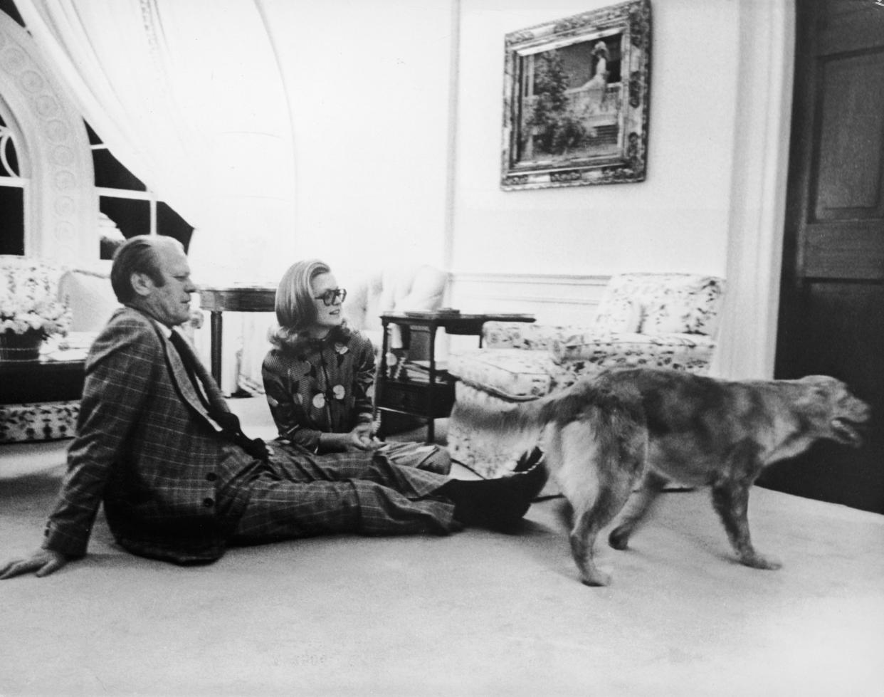 President Gerald Ford sits with his daughter Susan on the floor of the White House's Great Hall, watching their pet golden retriever 'Liberty,' Washington, DC, c. 1978. ( Pictorial Parade/Getty Images)