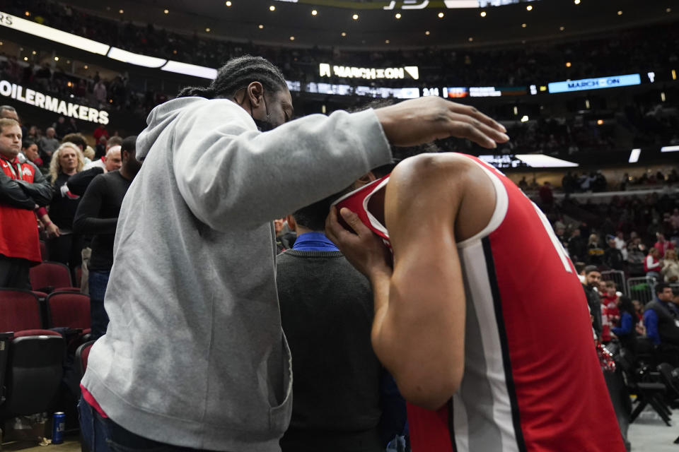 Ohio State's Justice Sueing is comforted following an NCAA semifinal basketball game against the Purdue at the Big Ten men's tournament, Saturday, March 11, 2023, in Chicago. (AP Photo/Erin Hooley)
