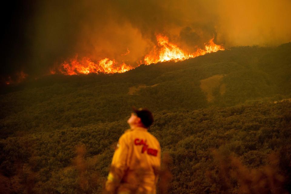 Battalion Chief Matt Sully directs operations on the Ranch fire, part of the Mendocino Complex fire, burning near Clearlake Oaks on Sunday. (Photo: NOAH BERGER via Getty Images)