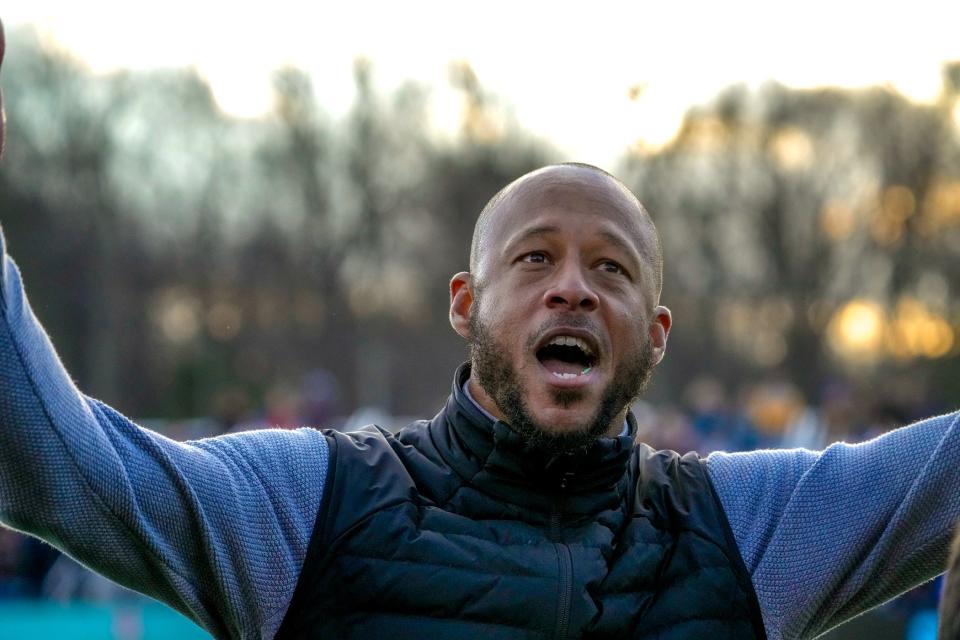 RIFC coach Khano Smith turns to fans for noise in the closing seconds of the tie game on Saturday.