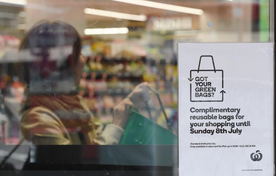 A sign notifying customers of reusable plastic bags  is seen at a Woolworths Sydney CBD store.