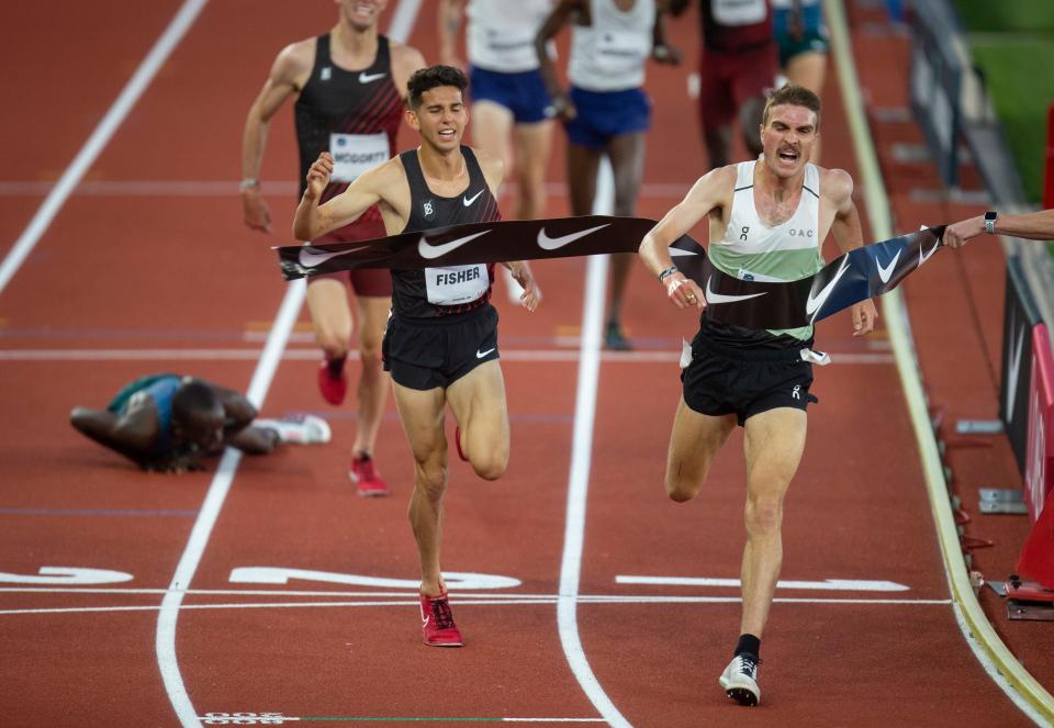 Joe Klecker, right, edges out Grant Fisher to win the men’s 10,000 meters at the 2022 Prefontaine Classic Friday, May 27, 2022, at Hayward Field. In the background, Emmanuel Bor falls and misses capturing third place, which went to Sean McGorty.