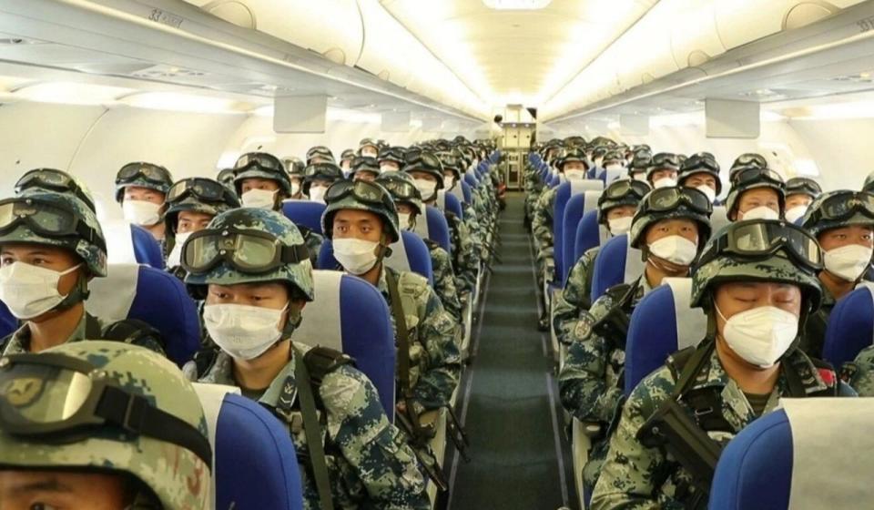 Pictured are dozens of Chinese military personnel on a plane. 