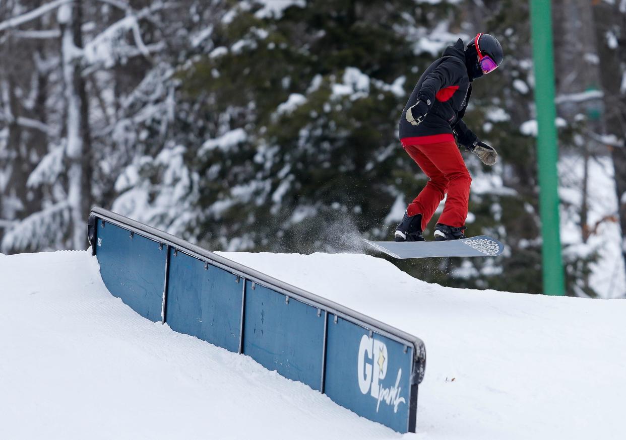 A snowboarder comes off of a jump on Friday, January 20, 2023, at Granite Peak Ski Area in Rib Mountain, Wis.