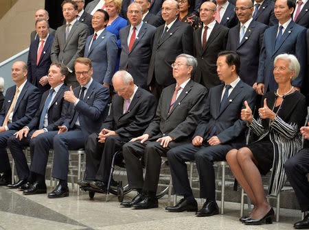 IMF Managing Director Christine Lagarde (R) and Bundesbank President Jens Weidmann (3rd L) give thumbs up after posing with ministers and bank governors for a family photo during the IMF and World Bank's 2017 Annual Spring Meetings, in Washington, U.S., April 21, 2017. REUTERS/Mike Theiler