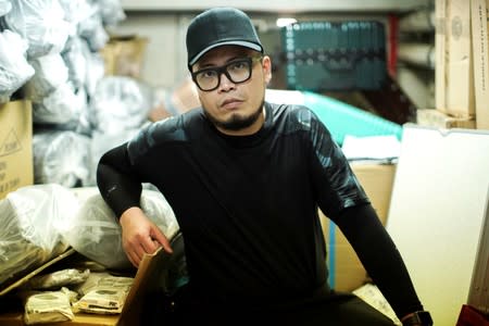 Keita Lee, 33, owner of the "National Calamity Hardware Store" poses at his shop in Hong Kong, China