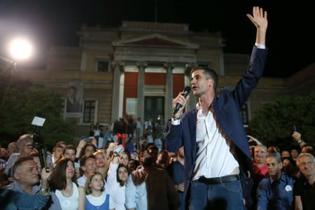 Newly elected mayor of Athens Kostas Bakoyannis waves to his supporters, at his election kiosk in Athens