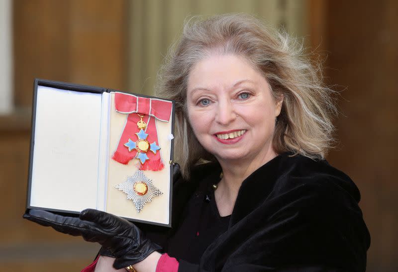 FILE PHOTO: Author Hilary Mantel poses with her Commander of the British Empire award at Buckingham Palace in London