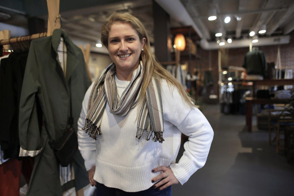 In this Thursday, Nov. 14, 2019, photo, Annie Venditti, vice president of operations at clothing retailer American Rhino, stands for a photograph in the store, in Faneuil Hall Marketplace, in Boston. At the age of 23, Venditti was learning about the complexities of building and liquor laws. The company did the smart thing, and got a consultant to guide them. (AP Photo/Steven Senne)