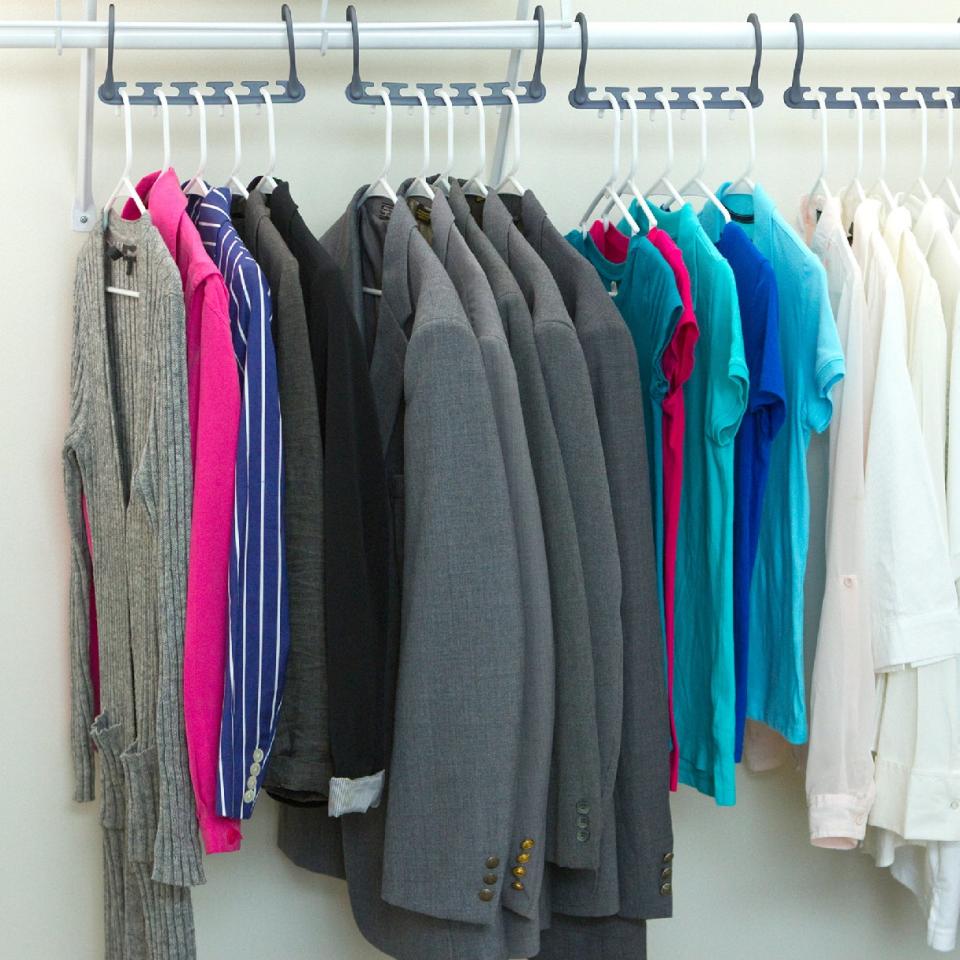 The hanger fully expanded horizontally, with five pieces of clothing hanging on each one