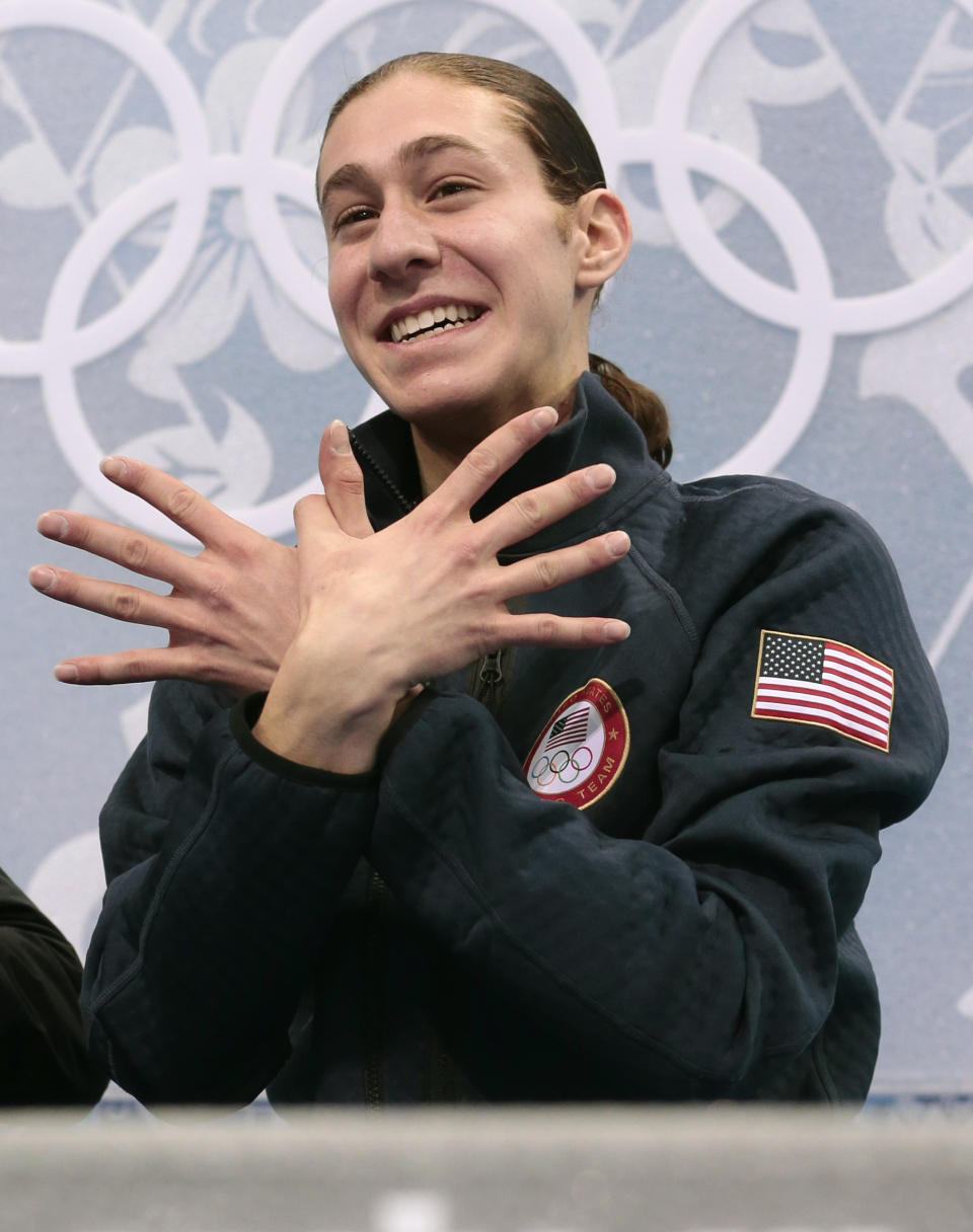 Jason Brown of the United States gestures to spectators in the results area after the men's short program figure skating competition at the Iceberg Skating Palace during the 2014 Winter Olympics, Thursday, Feb. 13, 2014, in Sochi, Russia. (AP Photo/Ivan Sekretarev)