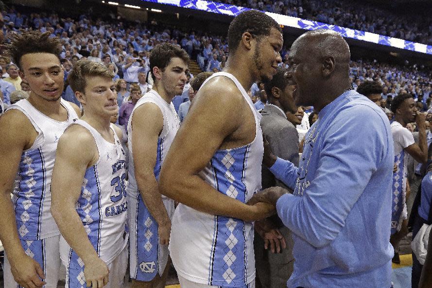 Former North Carolina basketball player Michael Jordan, right, congratulates Kennedy Meeks following North Carolina's win over Duke in an NCAA college basketball game in Chapel Hill, N.C., Saturday, March 4, 2017. (AP Photo/Gerry Broome)