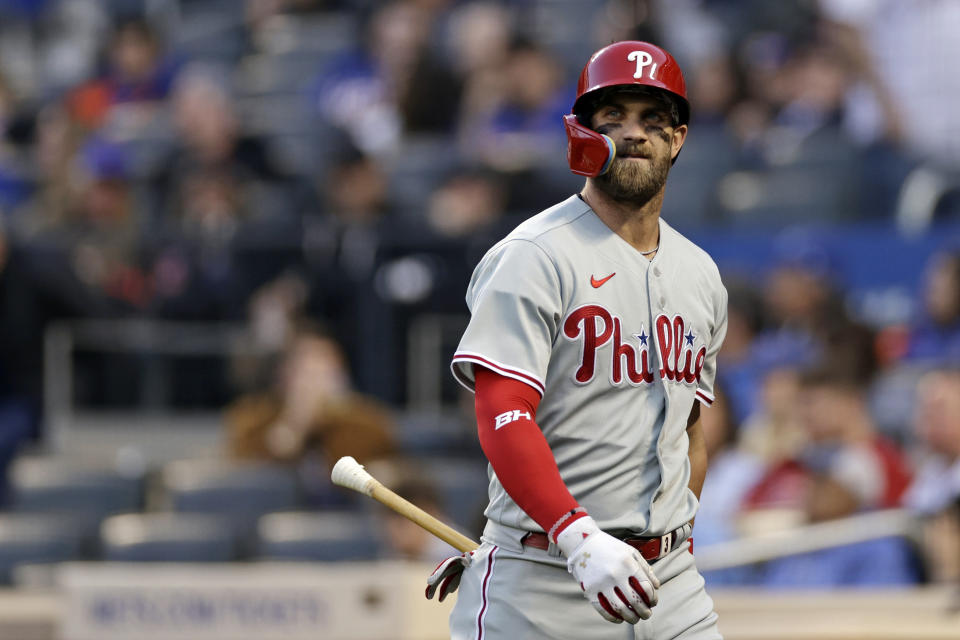 Philadelphia Phillies designated hitter Bryce Harper reacts after striking out during the first inning of a baseball game against the New York Mets on Saturday, April 30, 2022, in New York. (AP Photo/Adam Hunger)