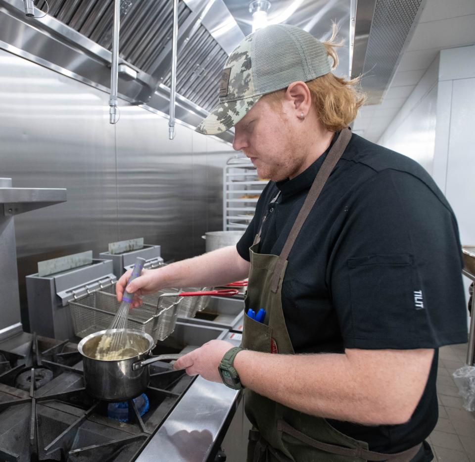 Chef de cuisine Taylor Stoll prepares a sauce at the new location of the Union Public House at 36 East Garden Street in Pensacola on Friday, Aug, 25, 2023.
