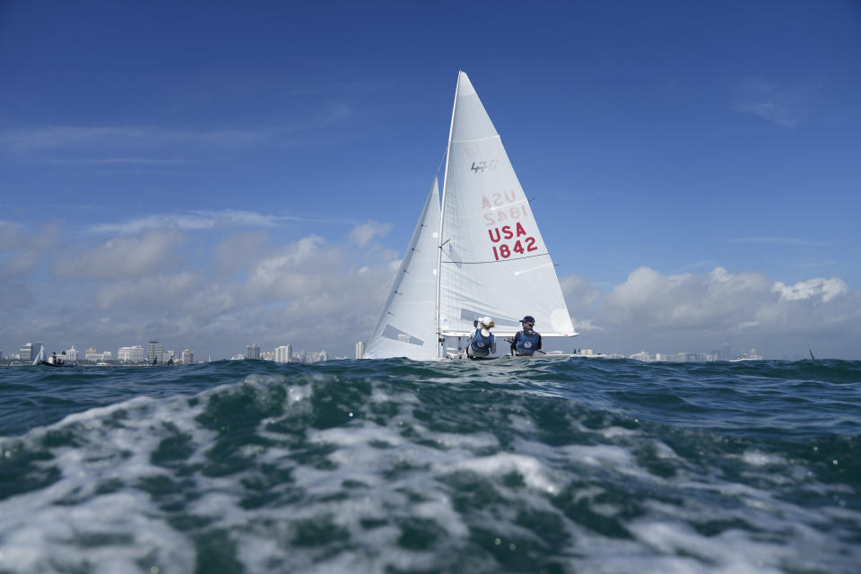 Lara Dallman-Weiss, left, and Stu McNay prepare to campaign in the mixed-gender 470 category at U.S. Sailing Olympic Trials, off the coast of Miami Beach, Fla., Friday, Jan. 12, 2024. McNay is returning for his fifth Olympics and teaming up with Dallman-Weiss, who competed in the women's 470 in the Tokyo Games, in the new mixed-gender category. (AP Photo/Rebecca Blackwell)