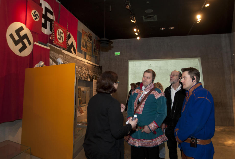 In this photo taken Tuesday, Feb. 21, 2012, Nils Ante Eira, center right, and Lars Joar Halonen, Sami of Norway, visit the Yad Vashem Holocaust memorial in Jerusalem, as part of their stay in Israel, viewed by many as a model for reviving ancient tongues. A delegation of Norway's indigenous Sami people visited Israel this week, to seek help in preserving and expanding their fading native language. According to a senior researcher at the Academy of Hebrew Language the Sami are not the first foreigners to look to Israel for language instruction tips; visitors from the Maori tribes of New Zealand, from Wales and from the Basque region of Spain have come before. (AP Photo/Sebastian Scheiner)