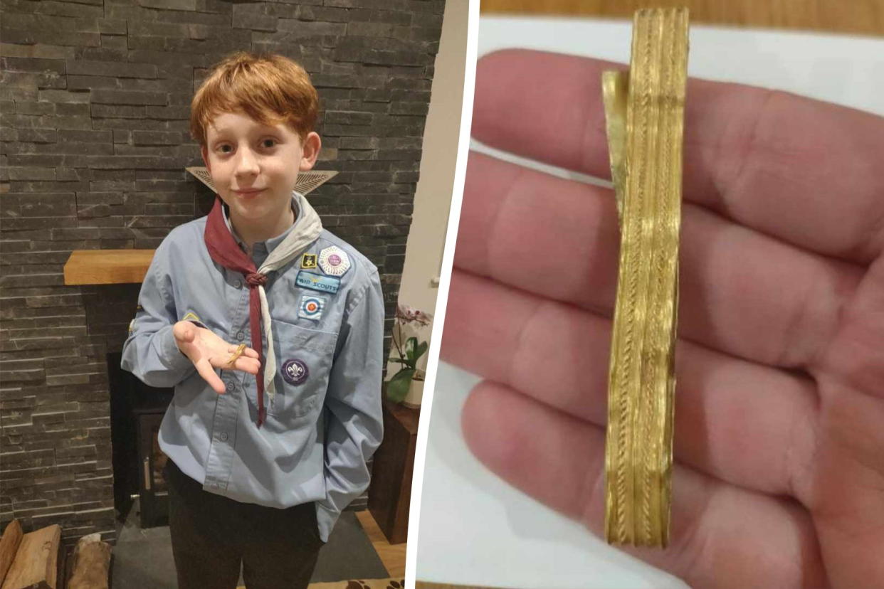 Rowan Brannan with a 2,000-year-old gold Roman bracelet that he found while walking with his mother through a field. (SWNS)