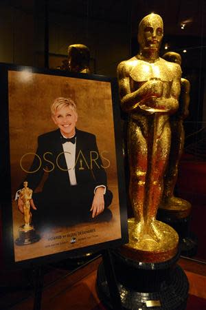 An Oscar statue and poster with host Ellen Degeneres is seen at the 86th Academy Awards nominee announcements in Beverly Hills, California January 16, 2014. REUTERS/Phil McCarten