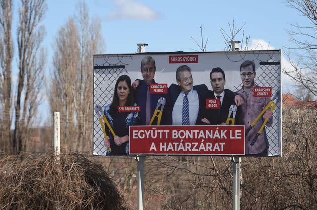 This picture taken on March 12, 2018, nearby Pecs, Hungary, shows a billboard featuring Hungarian-American billionaire and philanthropist George Soros (center) beside opposition candidates Bernadett Szel (left) of the green liberal LMP party, Ferenc Gyurcsany (second from left) of the Democratic Coalition, Gabor Vona (second from right) of Jobbik and Gergely Karacsony of the Dialogue for Hungary party. The text reads: 