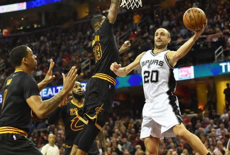 Jan 21, 2017; Cleveland, OH, USA; San Antonio Spurs guard Manu Ginobili (20) passes off against the Cleveland Cavaliers during the second half at Quicken Loans Arena. Mandatory Credit: Ken Blaze-USA TODAY Sports