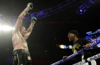 Tyson Fury, left, of England approaches his trainer Javon "SugarHill" Steward after defeating Deontay Wilder in a WBC heavyweight championship boxing match Saturday, Feb. 22, 2020, in Las Vegas. (AP Photo/Isaac Brekken)