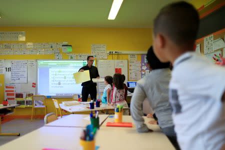 School children listen to their teacher Sebastien Ducoroy in their classroom at the Primary School Les Ormeaux in Montereau-Fault-Yonne near Paris, France, June 18, 2018. REUTERS/Gonzalo Fuentes/Files