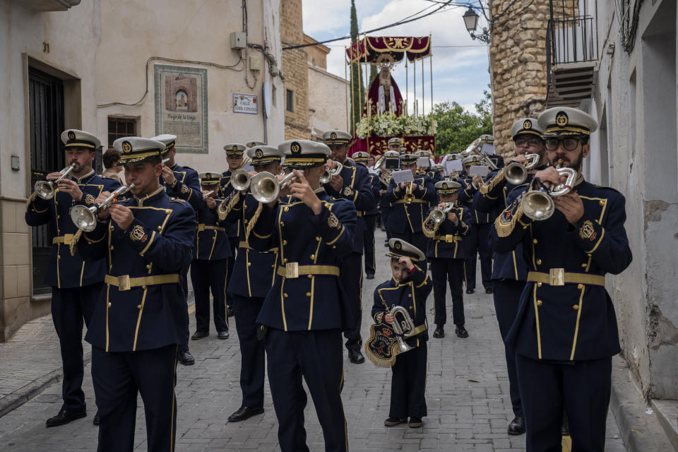 Members of a music band perform during a Holy Week procession in the southern town of Quesada, Spain, Friday, March 29, 2024. (AP Photo/Bernat Armangue)