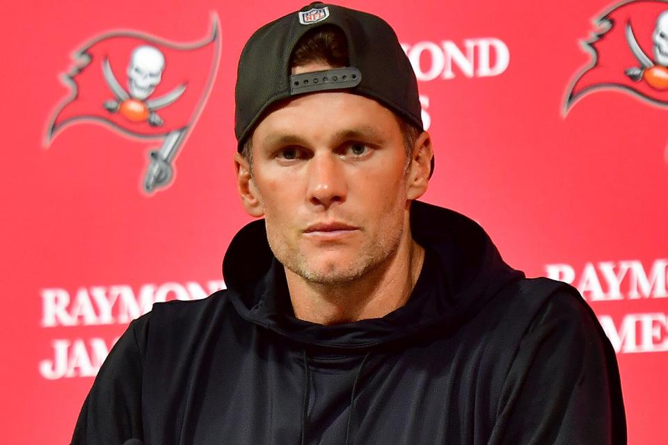 Tom Brady #12 of the Tampa Bay Buccaneers speaks to the media after losing to the Dallas Cowboys 31-14 in the NFC Wild Card playoff game at Raymond James Stadium on January 16, 2023 in Tampa, Florida.