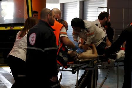 Medics evacuate an Israeli man who was injured during a Palestinian stabbing attack in the West Bank, at a hospital in Jerusalem February 24, 2016. REUTERS/Ammar Awad